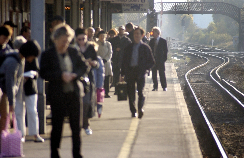 Passengers wait for the train