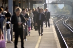 Passengers wait for the train